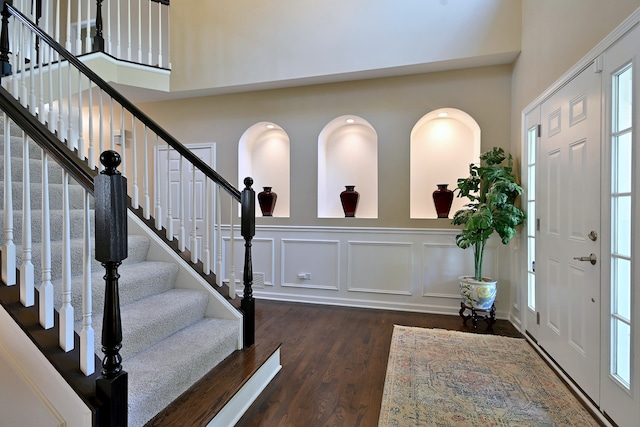 13464 Skyline Dr, Plainfield, IL 60585 - foyer entrance with wood finished floors, a high ceiling, stairway, and a decorative wall