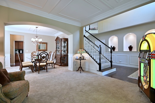 13464 Skyline Dr, Plainfield, IL 60585 - living room featuring arched walkways, a decorative wall, crown molding, a chandelier, and carpet