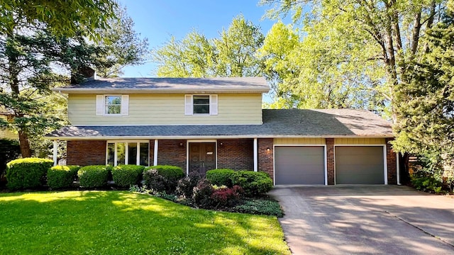 1305 Baugh Dr, Normal, IL 61761 - traditional-style home featuring an attached garage, a front yard, brick siding, and concrete driveway
