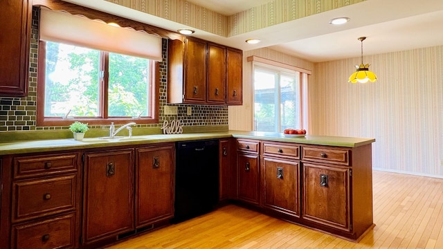 1305 Baugh Dr, Normal, IL 61761 - kitchen with black dishwasher, wallpapered walls, light wood finished floors, a peninsula, and light countertops