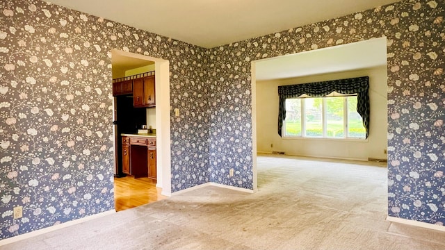 1305 Baugh Dr, Normal, IL 61761 - empty room with light colored carpet, wallpapered walls, and baseboards