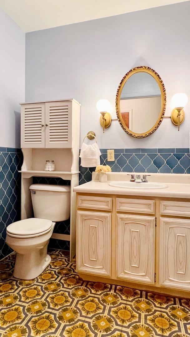 1305 Baugh Dr, Normal, IL 61761 - bathroom with toilet, tile walls, wainscoting, and vanity