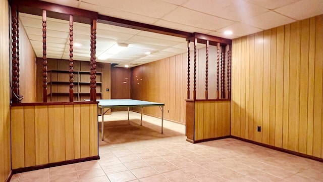 1305 Baugh Dr, Normal, IL 61761 - finished basement featuring wood walls, a paneled ceiling, baseboards, and tile patterned floors