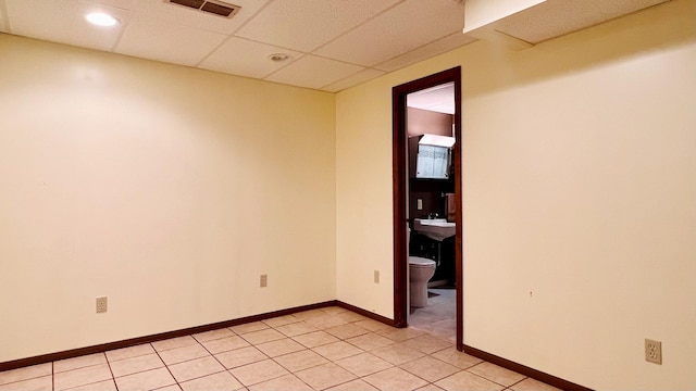 1305 Baugh Dr, Normal, IL 61761 - unfurnished room with light tile patterned flooring, a paneled ceiling, and baseboards