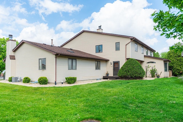 1868 Kerrybrook Ct Unit 1868, Sycamore, IL 60178 - rear view of house featuring a chimney, central AC, and a lawn