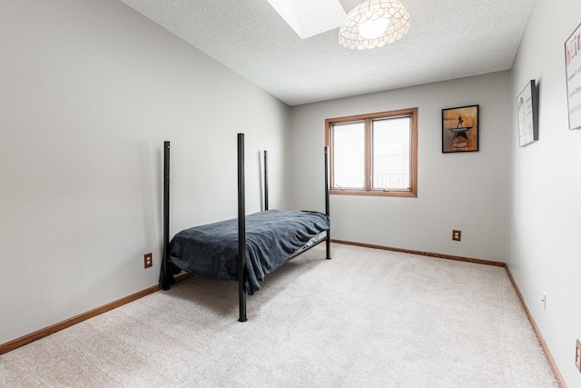 1868 Kerrybrook Ct Unit 1868, Sycamore, IL 60178 - bedroom featuring light colored carpet, a textured ceiling, a skylight, and baseboards