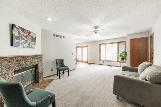 1868 Kerrybrook Ct Unit 1868, Sycamore, IL 60178 - living room with carpet flooring, a ceiling fan, a brick fireplace, a textured ceiling, and baseboards
