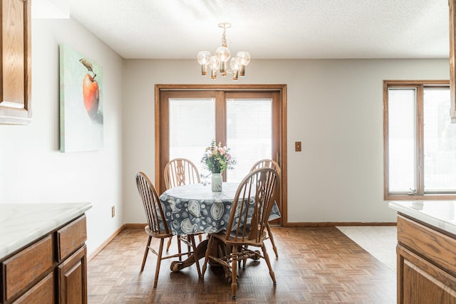 1868 Kerrybrook Ct Unit 1868, Sycamore, IL 60178 - dining space with a chandelier, baseboards, and a textured ceiling