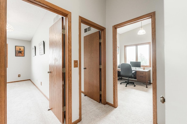 1868 Kerrybrook Ct Unit 1868, Sycamore, IL 60178 - corridor with light colored carpet, a desk, baseboards, and vaulted ceiling