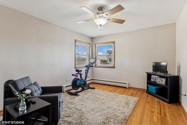 6810 N Ozark Ave Unit 9, Chicago, IL 60631 - exercise room with a baseboard heating unit, light wood-type flooring, ceiling fan, and baseboards