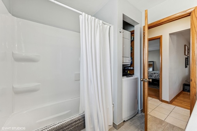 6810 N Ozark Ave Unit 9, Chicago, IL 60631 - bathroom featuring stacked washing machine and dryer, tile patterned floors, curtained shower, and ensuite bathroom