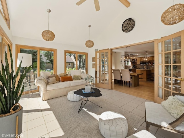 14705 Pleasant Valley Rd, Woodstock, IL 60098 - tiled living area with high vaulted ceiling, french doors, beamed ceiling, a ceiling fan, and a chandelier