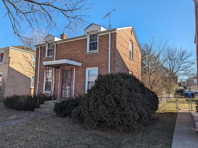 7317 S Mozart St, Chicago, IL 60629 - view of front of house featuring brick siding, a gate, a chimney, and fence