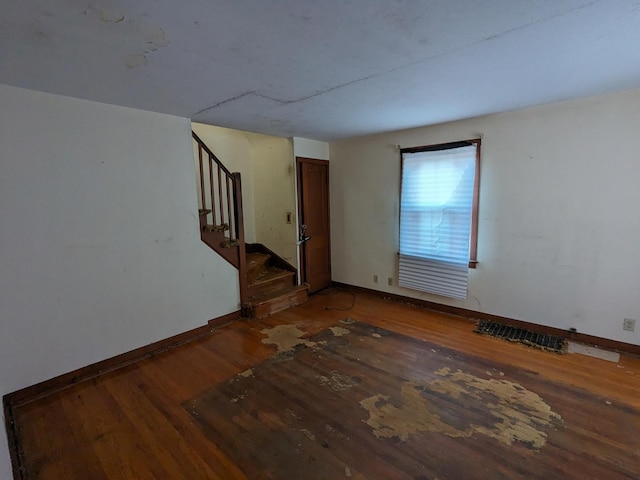7317 S Mozart St, Chicago, IL 60629 - unfurnished living room featuring wood-type flooring, stairway, and baseboards