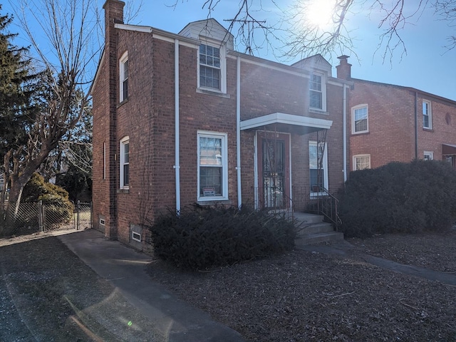 7317 S Mozart St, Chicago, IL 60629 - view of front of house with a chimney, brick siding, and fence