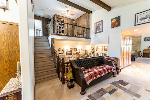 1479 Old Mill Rd, Franklin Grove, IL 61031 - living room featuring a high ceiling, beamed ceiling, stairway, a ceiling fan, and carpet floors