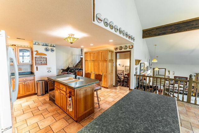 1479 Old Mill Rd, Franklin Grove, IL 61031 - kitchen with a sink, stone tile floors, dark countertops, a center island with sink, and black dishwasher
