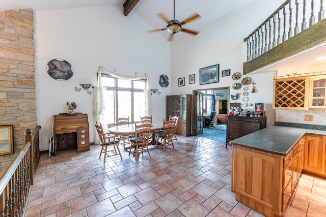 1479 Old Mill Rd, Franklin Grove, IL 61031 - dining area with high vaulted ceiling, beam ceiling, a ceiling fan, and stone tile floors
