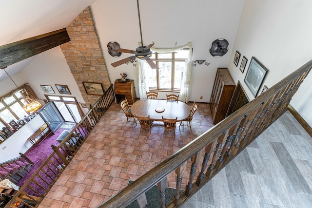 1479 Old Mill Rd, Franklin Grove, IL 61031 - dining area featuring high vaulted ceiling, a ceiling fan, baseboards, and stairs