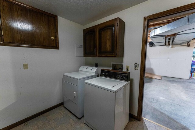 1479 Old Mill Rd, Franklin Grove, IL 61031 - laundry room featuring cabinet space, independent washer and dryer, baseboards, and a textured ceiling