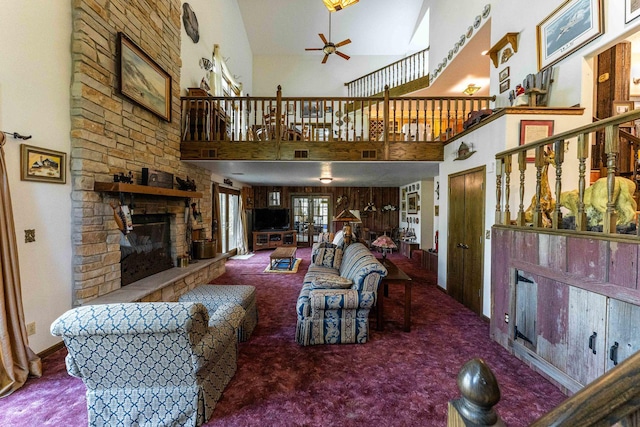1479 Old Mill Rd, Franklin Grove, IL 61031 - carpeted living room featuring a fireplace, ceiling fan, a high ceiling, and stairs