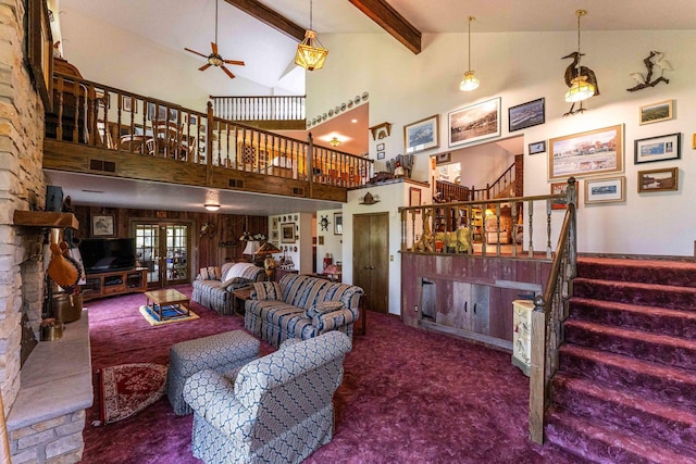 1479 Old Mill Rd, Franklin Grove, IL 61031 - living room featuring a ceiling fan, stairway, a stone fireplace, carpet flooring, and beam ceiling