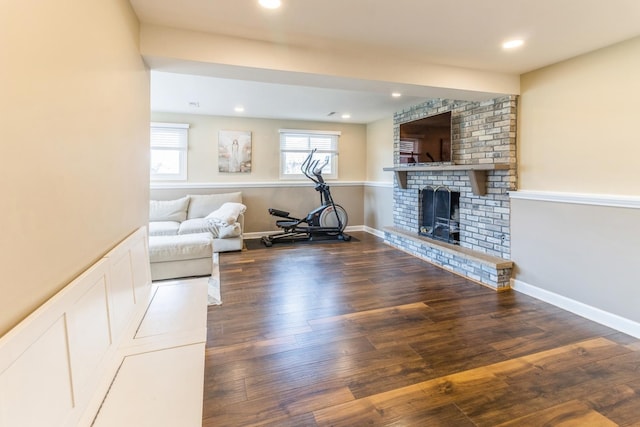 living room featuring wood finished floors, a fireplace, and recessed lighting