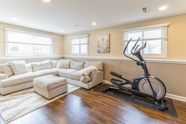 living room featuring wood finished floors, recessed lighting, and baseboards