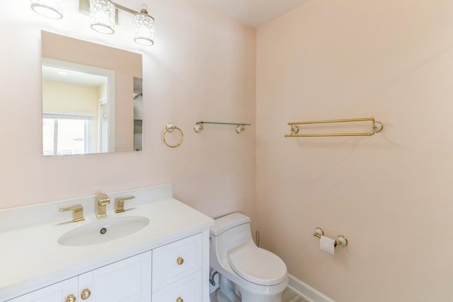 bathroom with toilet and vanity