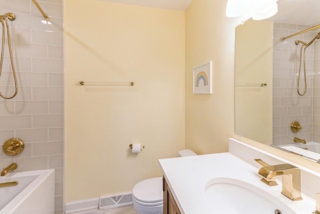 bathroom with bathing tub / shower combination, toilet, and vanity