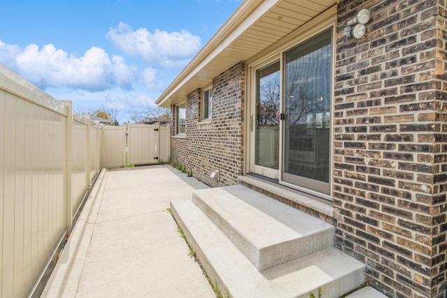 view of patio featuring a gate, fence, and entry steps