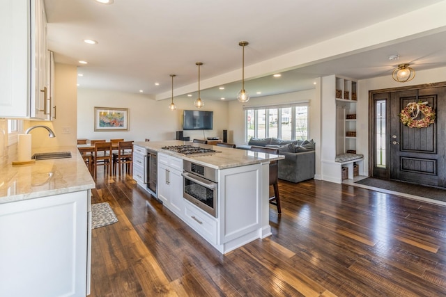 kitchen featuring stainless steel appliances, white cabinetry, a sink, dark wood-style floors, and recessed lighting