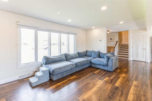 living room featuring dark wood-type flooring, stairs, recessed lighting, and baseboards
