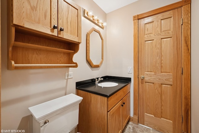 half bath featuring toilet and vanity