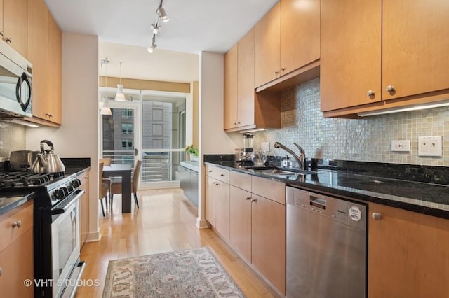 250 E Pearson St Unit 2006, Chicago, IL 60611 - kitchen with appliances with stainless steel finishes, light wood finished floors, a sink, dark stone countertops, and tasteful backsplash