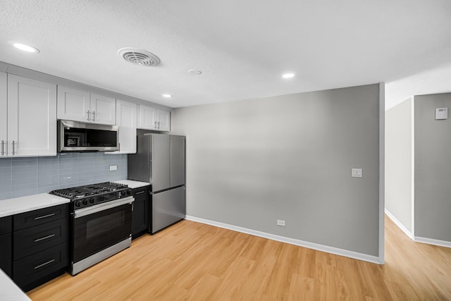 2825 S 13th Ave, Broadview, IL 60155 - kitchen with stainless steel appliances, light wood-type flooring, baseboards, light countertops, and backsplash
