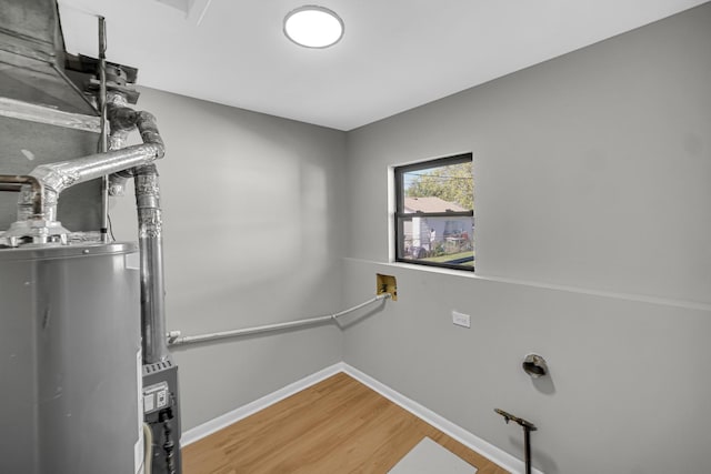 2825 S 13th Ave, Broadview, IL 60155 - washroom featuring wood finished floors, water heater, and baseboards