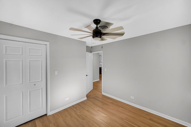 2825 S 13th Ave, Broadview, IL 60155 - unfurnished bedroom featuring baseboards, light wood-type flooring, a closet, and a ceiling fan