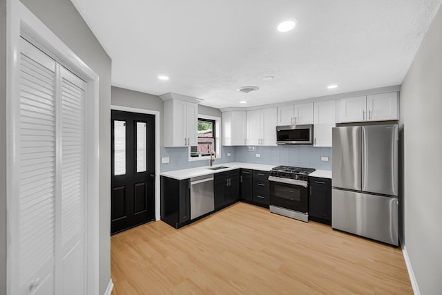 2825 S 13th Ave, Broadview, IL 60155 - kitchen with appliances with stainless steel finishes, a sink, tasteful backsplash, light countertops, and recessed lighting