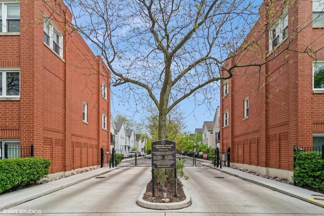 1835 W Oakdale Ave Unit E, Chicago, IL 60657 - view of concrete road featuring a residential view, curbs, a gate, and sidewalks