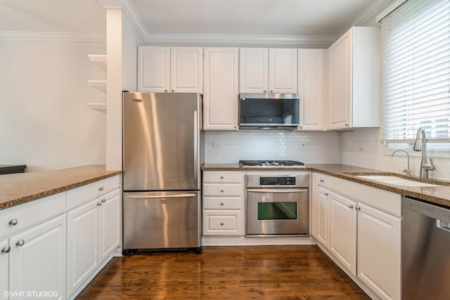 1835 W Oakdale Ave Unit E, Chicago, IL 60657 - kitchen featuring stainless steel appliances, a sink, stone counters, white cabinets, and ornamental molding