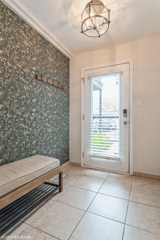 1835 W Oakdale Ave Unit E, Chicago, IL 60657 - doorway to outside featuring wallpapered walls, a chandelier, baseboards, light tile patterned flooring, and an accent wall