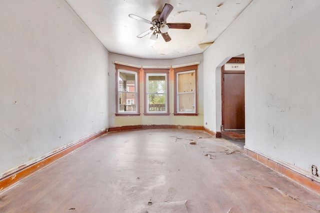 7813 S May St, Chicago, IL 60620 - unfurnished room featuring arched walkways, ceiling fan, concrete flooring, and baseboards