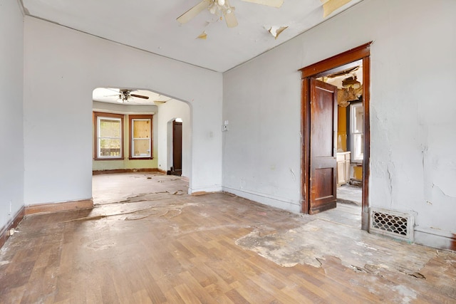 7813 S May St, Chicago, IL 60620 - empty room with ceiling fan, arched walkways, baseboards, and wood finished floors