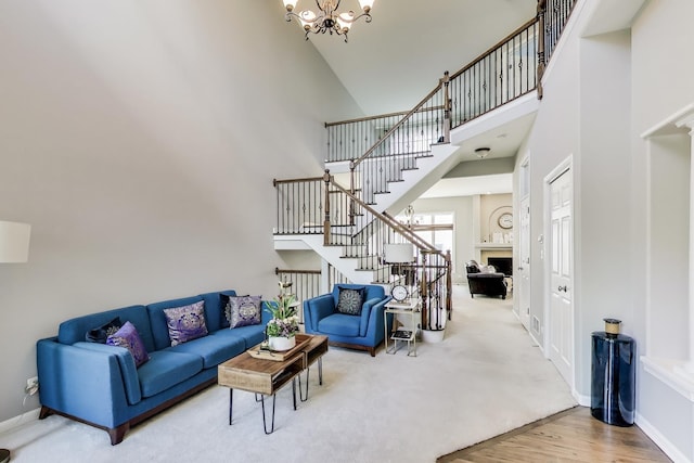1571 W Rue James Pl, Palatine, IL 60067 - living area featuring a chandelier, a high ceiling, stairway, baseboards, and wood finished floors