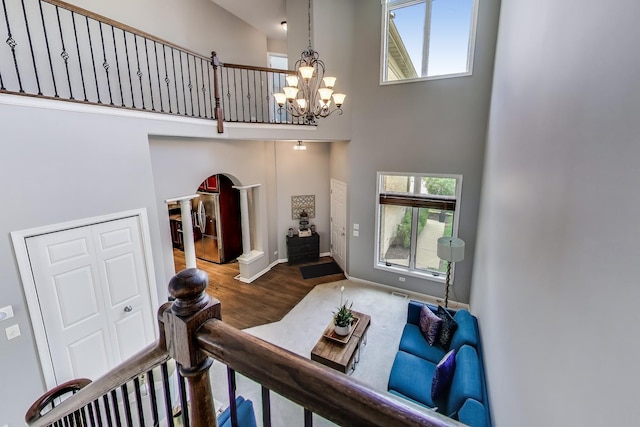 1571 W Rue James Pl, Palatine, IL 60067 - foyer entrance with a high ceiling, arched walkways, wood finished floors, a chandelier, and baseboards