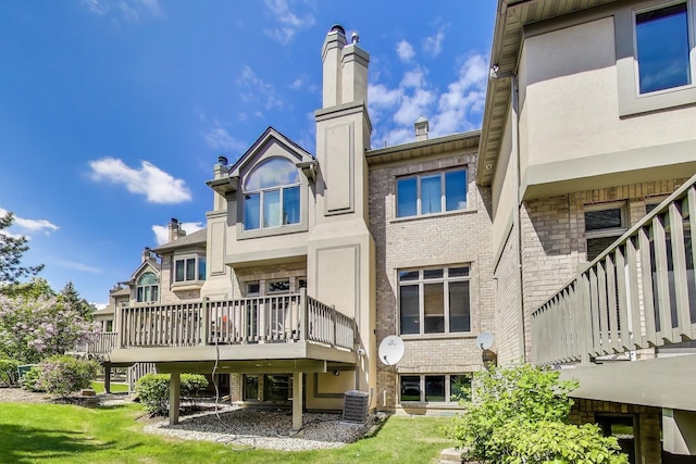 1571 W Rue James Pl, Palatine, IL 60067 - rear view of property with cooling unit, brick siding, a chimney, and a deck