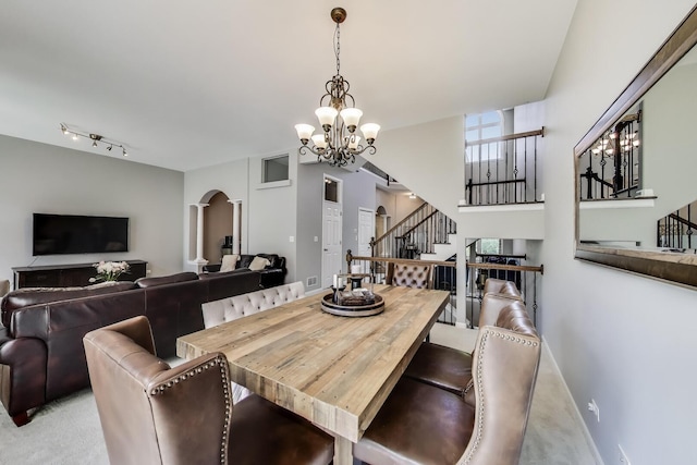 1571 W Rue James Pl, Palatine, IL 60067 - dining room featuring arched walkways, a chandelier, stairs, and carpet
