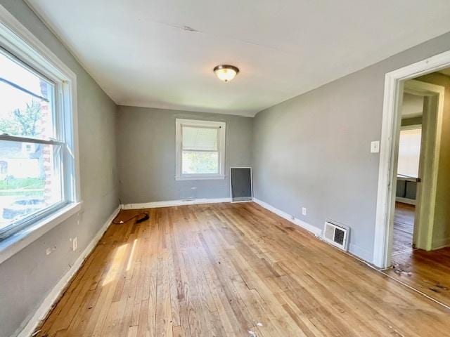 empty room with light wood-style flooring and baseboards