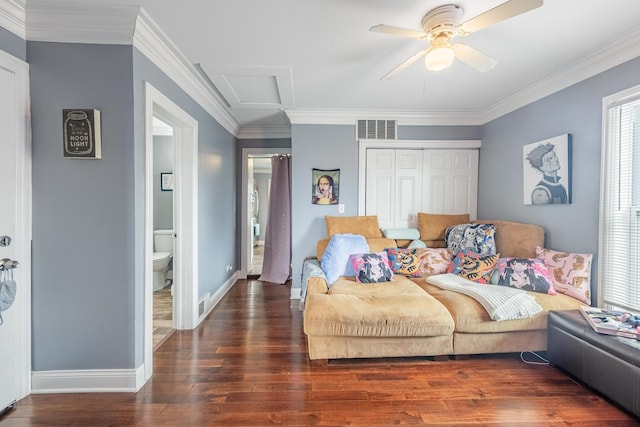 bedroom featuring wood finished floors, a closet, baseboards, ornamental molding, and attic access